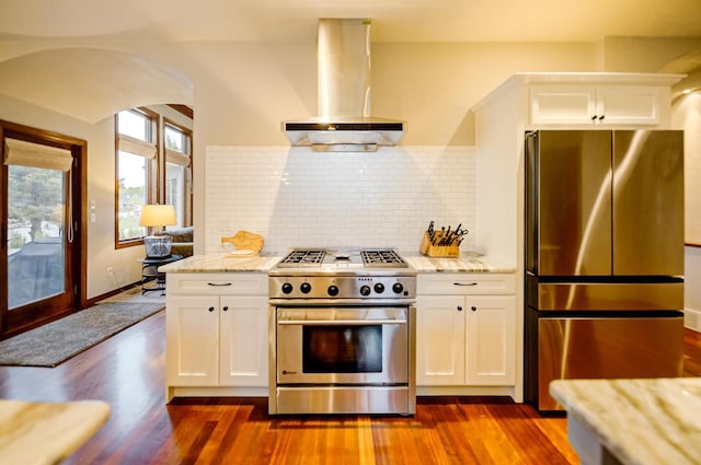 870 Eden Ct, Menasha, WI 54956 - kitchen featuring appliances with stainless steel finishes, island exhaust hood, dark wood-type flooring, backsplash, and white cabinetry