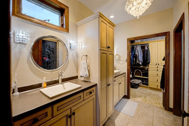 870 Eden Ct, Menasha, WI 54956 - bathroom featuring a chandelier, two vanities, tile patterned floors, and a walk in closet