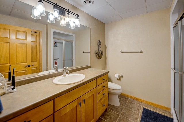 870 Eden Ct, Menasha, WI 54956 - bathroom featuring an enclosed shower, tile patterned floors, a drop ceiling, vanity, and toilet