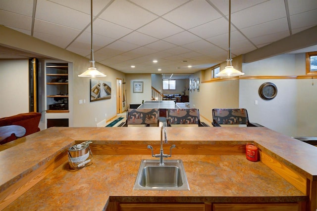 870 Eden Ct, Menasha, WI 54956 - kitchen with a sink, open floor plan, brown cabinets, and decorative light fixtures