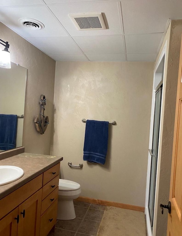870 Eden Ct, Menasha, WI 54956 - bathroom with a stall shower, a textured wall, vanity, a drop ceiling, and tile patterned floors