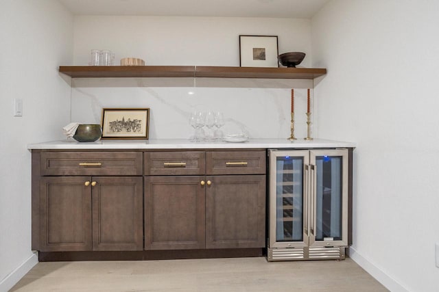 2285 N 166th St, Brookfield, WI 53005 - indoor dry bar featuring beverage cooler, baseboards, and light wood finished floors