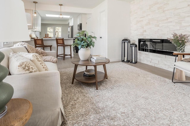 2285 N 166th St, Brookfield, WI 53005 - living area featuring wood finished floors, a fireplace, and baseboards