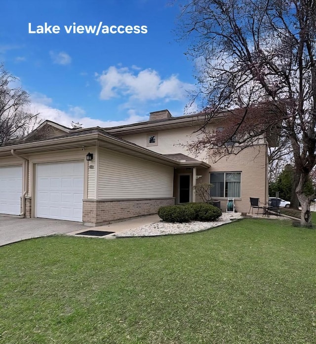 26 Waunona Woods Ct, Madison, WI 53713 - view of front of home with brick siding, a front yard, concrete driveway, a garage, and a chimney