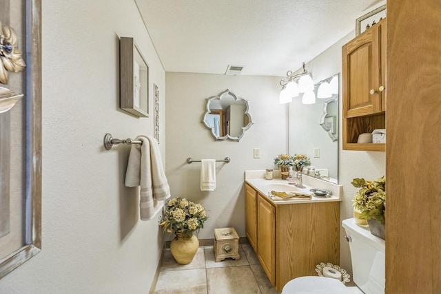 26 Waunona Woods Ct, Madison, WI 53713 - bathroom featuring tile patterned floors, toilet, vanity, and baseboards