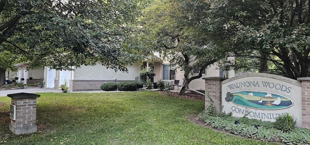 26 Waunona Woods Ct, Madison, WI 53713 - community sign with a yard, driveway, and a garage