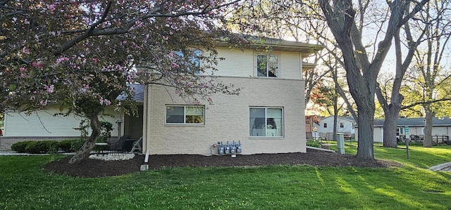 26 Waunona Woods Ct, Madison, WI 53713 - rear view of property featuring a lawn and brick siding