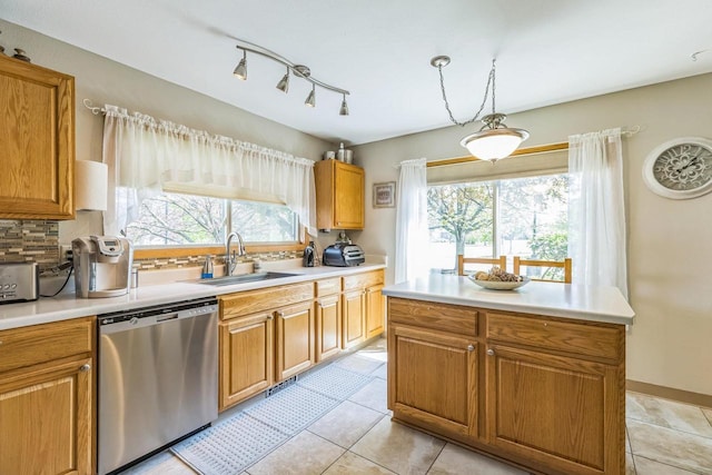 26 Waunona Woods Ct, Madison, WI 53713 - kitchen with dishwasher, a sink, healthy amount of natural light, and brown cabinets