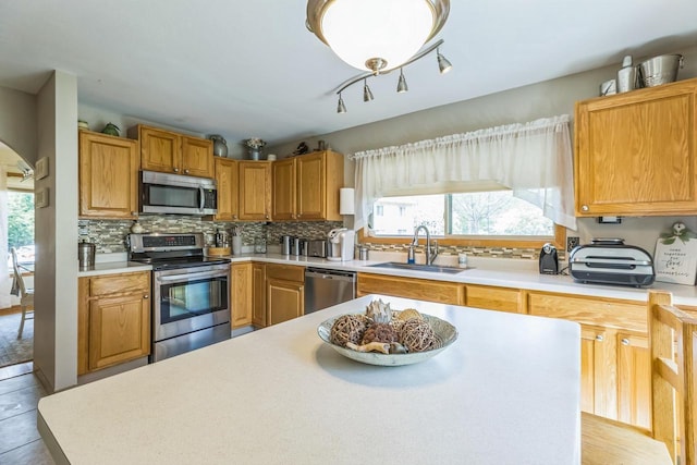 26 Waunona Woods Ct, Madison, WI 53713 - kitchen with stainless steel appliances, a sink, healthy amount of natural light, and backsplash