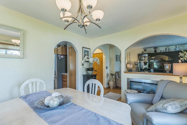 26 Waunona Woods Ct, Madison, WI 53713 - dining space with arched walkways and a chandelier