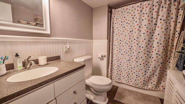 W7660 State Road 21, Wautoma, WI 54982 - full bathroom featuring vanity, a shower with shower curtain, wainscoting, tile patterned floors, and toilet