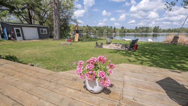 W7660 State Road 21, Wautoma, WI 54982 - wooden terrace featuring a water view, an outdoor fire pit, a yard, and an outdoor structure