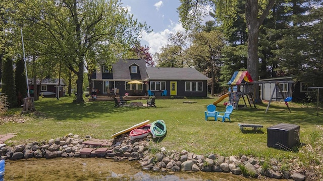 W7660 State Road 21, Wautoma, WI 54982 - back of house with a playground and a lawn