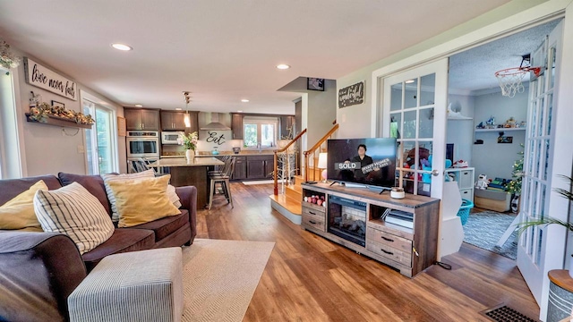 W7660 State Road 21, Wautoma, WI 54982 - living room featuring wood finished floors, recessed lighting, and stairway