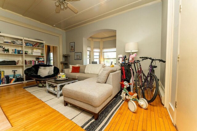 306 Wisconsin St, Oshkosh, WI 54901 - living area featuring arched walkways, ornamental molding, wood-type flooring, and a ceiling fan