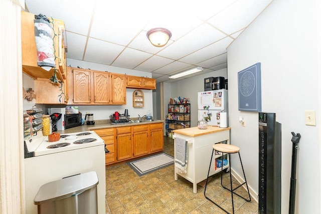 306 Wisconsin St, Oshkosh, WI 54901 - kitchen featuring a paneled ceiling, light countertops, and white appliances