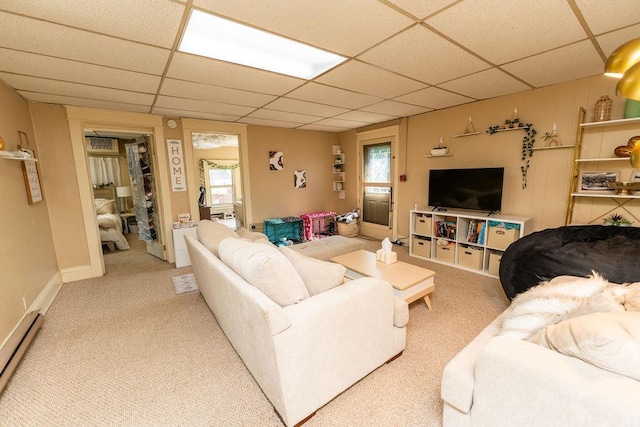 306 Wisconsin St, Oshkosh, WI 54901 - living area featuring a baseboard radiator, a drop ceiling, and light carpet