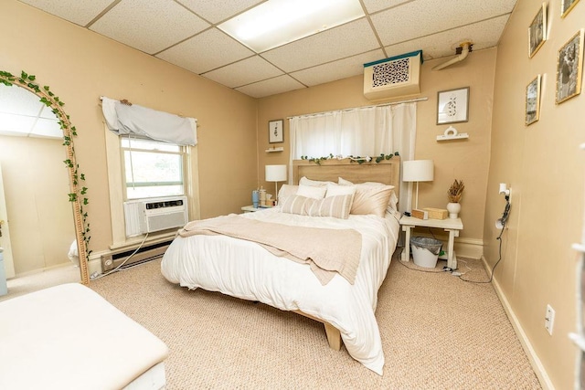 306 Wisconsin St, Oshkosh, WI 54901 - bedroom with a baseboard heating unit, a paneled ceiling, light carpet, baseboards, and cooling unit