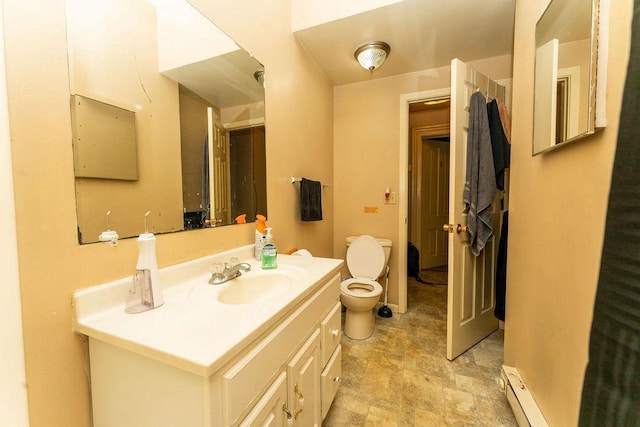 306 Wisconsin St, Oshkosh, WI 54901 - bathroom featuring a baseboard radiator, vanity, toilet, and stone finish flooring