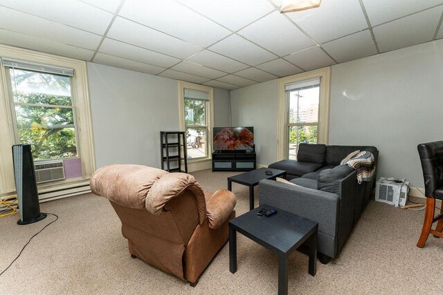 306 Wisconsin St, Oshkosh, WI 54901 - living area with a paneled ceiling, light colored carpet, plenty of natural light, and a baseboard radiator