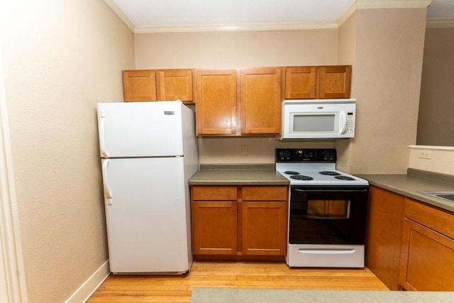 306 Wisconsin St, Oshkosh, WI 54901 - kitchen with white appliances, crown molding, brown cabinets, light wood-type flooring, and a sink