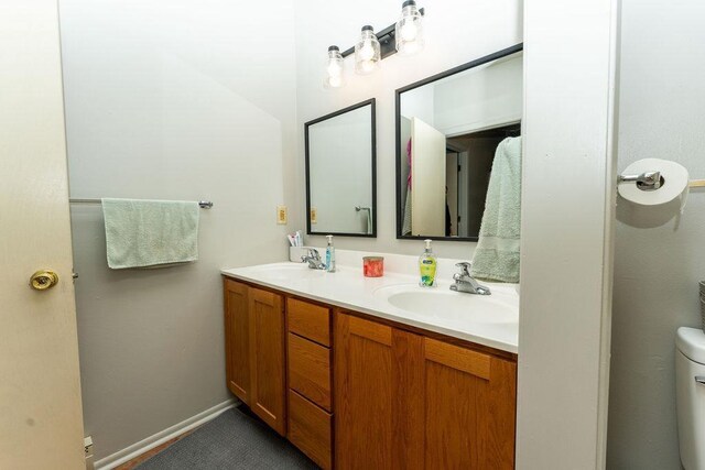 306 Wisconsin St, Oshkosh, WI 54901 - bathroom with double vanity and toilet