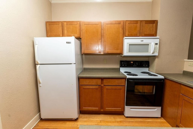306 Wisconsin St, Oshkosh, WI 54901 - kitchen with white appliances, brown cabinets, light wood-style flooring, and crown molding