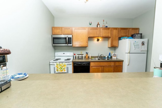 306 Wisconsin St, Oshkosh, WI 54901 - kitchen with white appliances, a sink, light countertops, and brown cabinetry