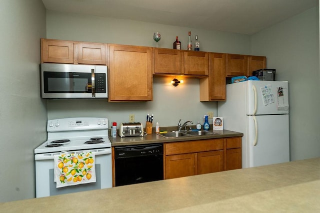 306 Wisconsin St, Oshkosh, WI 54901 - kitchen with white appliances, a sink, and brown cabinetry