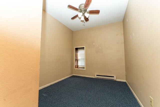 306 Wisconsin St, Oshkosh, WI 54901 - carpeted empty room with baseboard heating, ceiling fan, baseboards, and vaulted ceiling