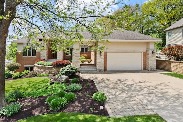 1260 Eagle Dr, Lake Geneva, WI 53147 - view of front of house with driveway, a garage, stucco siding, and roof with shingles