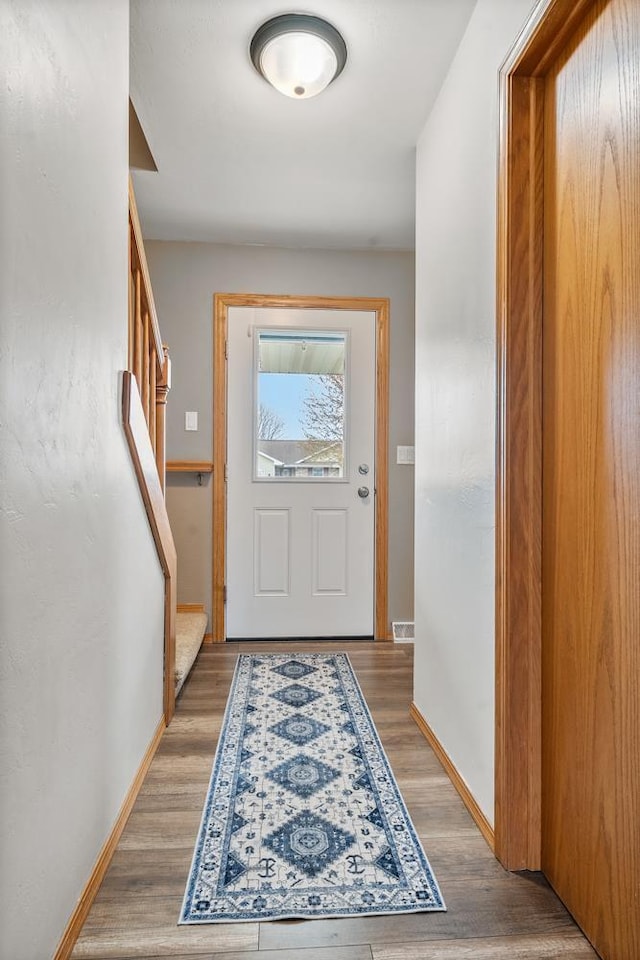 2731 Hamilton St, Oshkosh, WI 54901 - doorway featuring light wood-type flooring, stairway, and baseboards