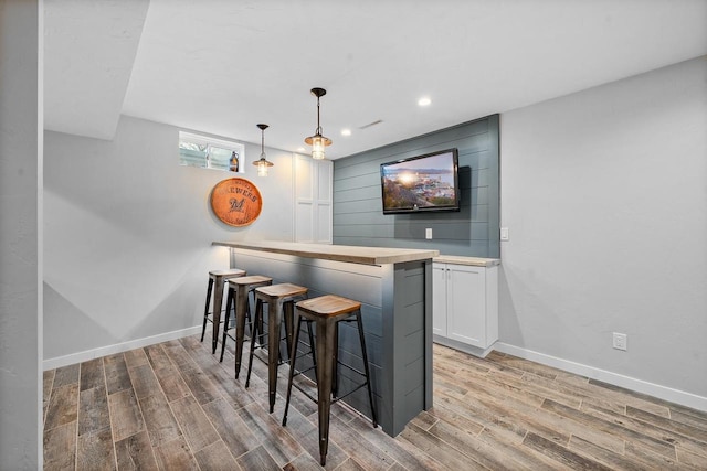 2731 Hamilton St, Oshkosh, WI 54901 - indoor bar featuring wood finished floors, baseboards, recessed lighting, and decorative light fixtures
