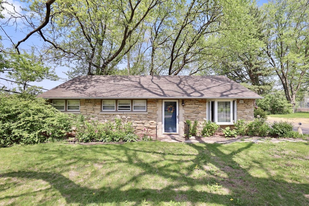 W209N7020 Fillmore Dr, Menomonee Falls, WI 53051 - view of front of home featuring stone siding and a front lawn