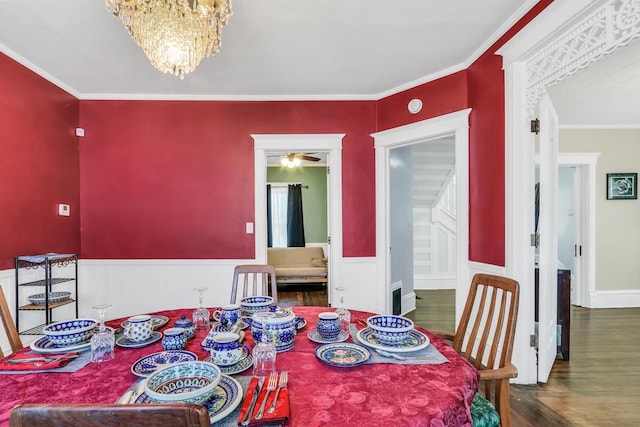 822 12th Ave, Union Grove, WI 53182 - dining area featuring wood finished floors, a chandelier, a wainscoted wall, and crown molding