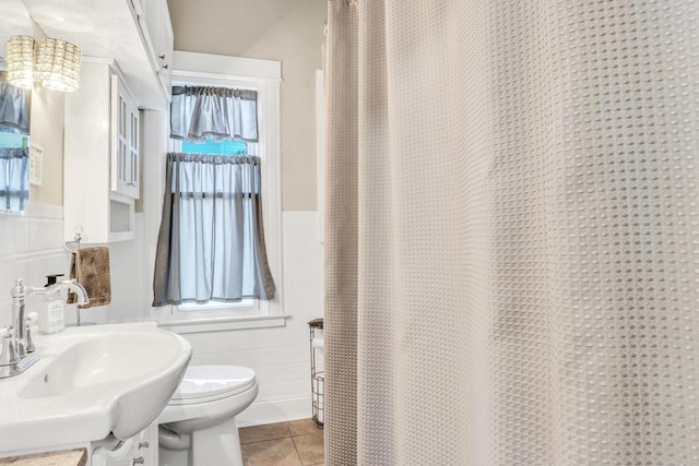 822 12th Ave, Union Grove, WI 53182 - full bathroom with a sink, tile walls, tile patterned floors, a wainscoted wall, and toilet