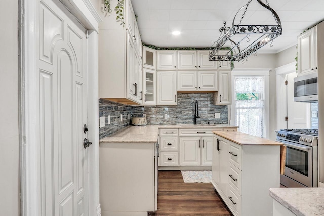 822 12th Ave, Union Grove, WI 53182 - kitchen featuring stainless steel appliances, a sink, white cabinetry, and decorative backsplash