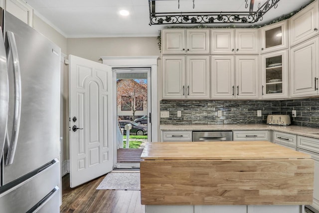 822 12th Ave, Union Grove, WI 53182 - kitchen with appliances with stainless steel finishes, butcher block counters, healthy amount of natural light, dark wood-style floors, and ornamental molding