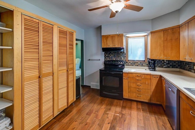 1614 Lake View Ave, Madison, WI 53704 - kitchen with black range with electric cooktop, dishwasher, under cabinet range hood, ceiling fan, and brown cabinetry