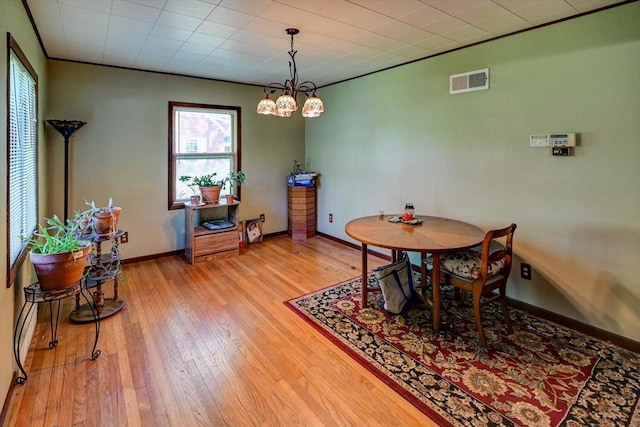 1614 Lake View Ave, Madison, WI 53704 - dining room featuring light wood-style flooring, baseboards, and a chandelier