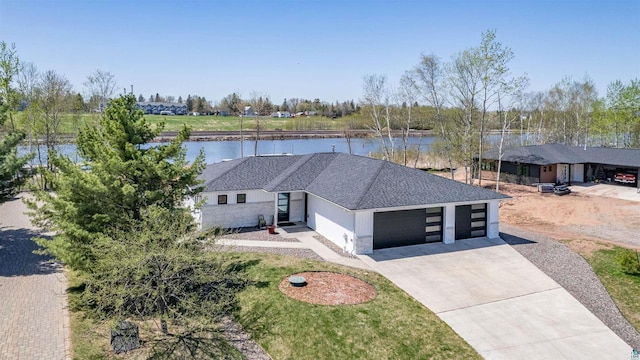 546 Marina Dr, Superior, WI 54880 - view of front of house with an attached garage, a water view, concrete driveway, and a shingled roof
