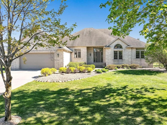 2531 Huntington Way, Suamico, WI 54173 - french country inspired facade with concrete driveway, an attached garage, brick siding, and a front yard