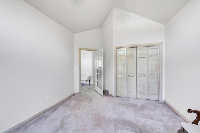 2531 Huntington Way, Suamico, WI 54173 - unfurnished bedroom featuring vaulted ceiling, light colored carpet, and baseboards