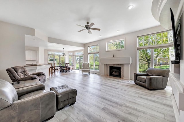 2531 Huntington Way, Suamico, WI 54173 - living area featuring ceiling fan, a premium fireplace, light wood finished floors, a chandelier, and recessed lighting