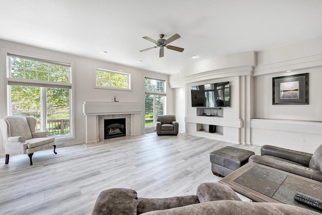 2531 Huntington Way, Suamico, WI 54173 - living area featuring a premium fireplace, wood finished floors, and a ceiling fan