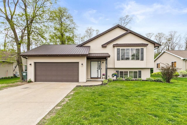 632 Grove St, Portage, WI 53901 - split level home featuring an attached garage, driveway, a front yard, metal roof, and a standing seam roof