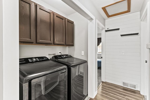 632 Grove St, Portage, WI 53901 - laundry area with separate washer and dryer, cabinet space, and wood finished floors