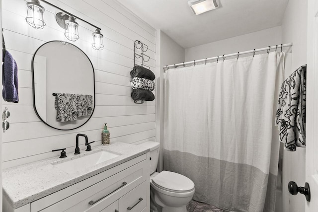 632 Grove St, Portage, WI 53901 - bathroom featuring toilet, vanity, and wood walls