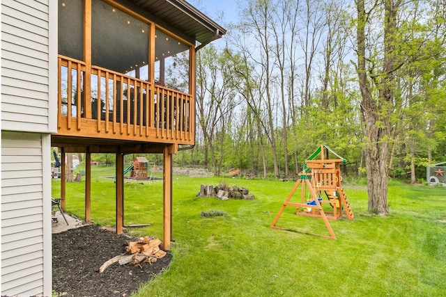 632 Grove St, Portage, WI 53901 - view of grassy yard with a playground and a wooden deck