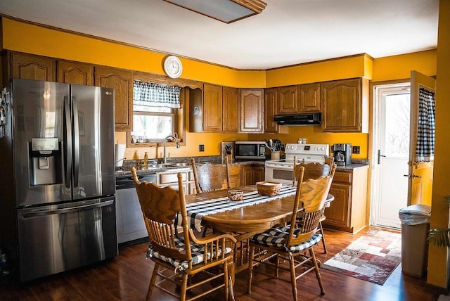 33902 County Rd N Unit L4, Hillpoint, WI 53937 - kitchen featuring stainless steel appliances, a sink, under cabinet range hood, and brown cabinetry